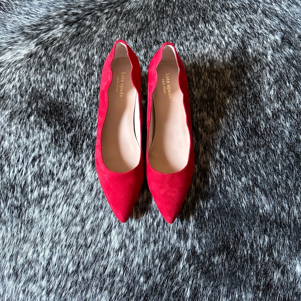 Kate Spade red pumps with petal shape side detail. Never worn.